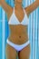 Attractive female torso in bronzing indoor tanning bed