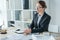 attractive financier working with documents at table