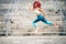 Attractive fit girl training and running. Portrait of fitness girl jumping during training