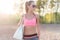 Attractive fit woman in sportswear training outdoors, female athlete with perfect body resting after workout, fashion