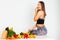 Attractive fitness woman, trained female Fit power athletic confident young woman bodybuilder eating veg , Organic Food.