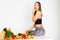 Attractive fitness woman, trained female Fit power athletic confident young woman bodybuilder eating veg , Organic Food.