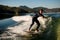 attractive flexible man in wetsuit on wakesurf skilfully riding on splashing wave