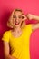 Attractive funky teenage girl in yellow t shirt over vibrant pin