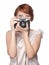 Attractive funny girl with a camera over white
