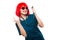 Attractive funny smilling caucasian brunette female doctor in red wig and red sunglasses standing in office having a