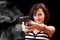 Attractive girl aiming with gun with smoke