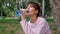 Attractive girl blonde drink water with pleasure outdoors. A young woman is drinking clean water from a plastic bottle