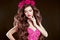 Attractive girl with chaplet of roses on head, long wavy hair st