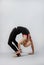 Attractive girl gymnast performs a complex exercise. Flexibility, stretching