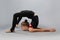 Attractive girl gymnast performs a complex exercise. Flexibility, stretching