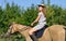 Attractive girl horseback riding