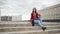 Attractive girl with long hair sitting on steps