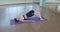 Attractive girl in pink sport outfit doing fitness exercise indoor in spa hotel