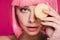 Attractive girl in pink wig posing with yellow macaron isolated