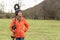 Attractive girl posing standing with metal detector on the shoulder on the background of the field