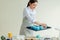 Attractive girl putting cupcake liner on the oven sheet at home kitchen