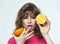 Attractive girl seductively holds oranges in her hands photo shoot in the studio on a white background