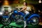 Attractive girl sitting on a blue motorcycle, moto show