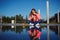 Attractive girl sitting next to the water