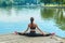 Attractive girl in sportswear does gymnastic exercises on a wooden pier in a city park