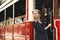 Attractive girl standing in the doorway of red retro tram on the street. Popular sight of Istanbul, Turkey. District