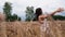 Attractive girl in a wheat field. Falling onto soft ears.