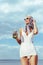 attractive girl in white vintage swimsuit holding mason jar