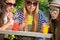 Attractive girlfriends enjoying cocktails in an outdoor cafe, friendship concept