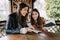 Attractive girls reading books and smiling in gazebo