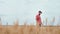 Attractive guy farmer in the middle of young wheat field he walking around touching the wheat and feeling excited