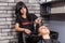 Attractive hairdresser combing hair of beautiful woman in washing sink