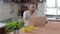 Attractive handsome man with beard watching game on laptop in kitchen