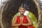 Attractive and happy 40s or 50s middle aged Asian woman in classy and beautiful red dress practicing yoga relaxation and