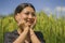 Attractive and happy Asian Chinese woman 40s or 50s enjoying nature excited and carefree playful at tropical rice field during