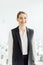 attractive and happy businesswoman in formal wear smiling in conference hall.