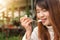 Attractive happy cute young asian woman sitting and eating dessert at outdoors cafe. Food, junk-food, culinary, baking and holiday