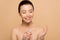 Attractive happy nude asian woman using antiseptic spray