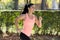 Attractive and happy runner woman in Autumn sportswear running and training on jogging outdoors workout in city park