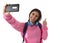 Attractive and happy woman or student girl with backpack and headphones taking selfie photo