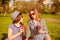 Attractive happy women in glasses having picnic and drinking coffee