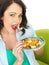 Attractive Happy Young Hispanic Woman Eating a Plate of Seafood Linguine