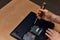 Attractive hardworking guy dismantling laptop with screwdriver, closeup view