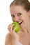 Attractive healthy girl biting an apple isolated