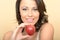 Attractive Healthy Young Woman Holding a Juicy Ripe Shiny Apple