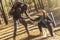 Attractive hiker helping his girlfriend uphill in the countryside