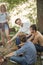 Attractive hikers hilding sticks on the campfire