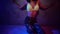Attractive hip hop dancer in smoky studio with neon lights