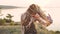 Attractive hippie woman with dreadlocks at sunset having good time and dance outdoors