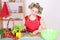 Attractive housewife with vegetables in the kitchen